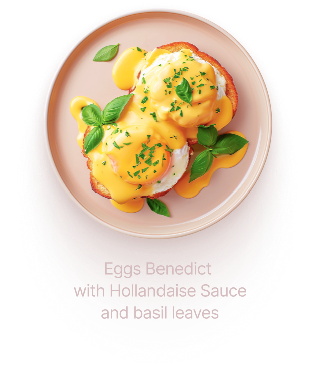 Eggs Benedict with Hollandaise Sauce and basil leaves